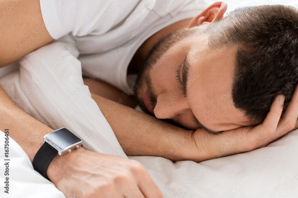 close up of man with smartwatch sleeping in bed close up of man with smartwatch sleeping in bed
