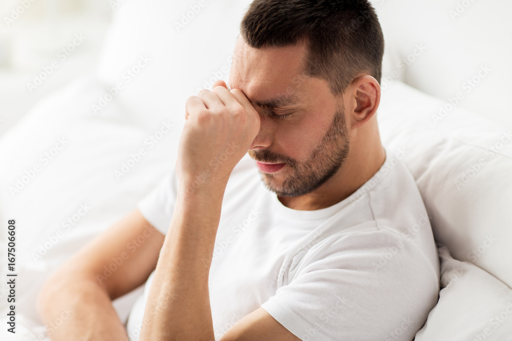 close up of stressed man in bed at home close up of stressed man in bed at home