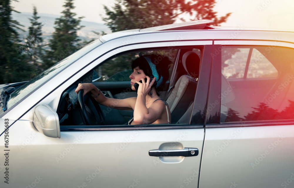 Pretty woman driving the car and talking on phone Pretty woman driving the car and talking on phone