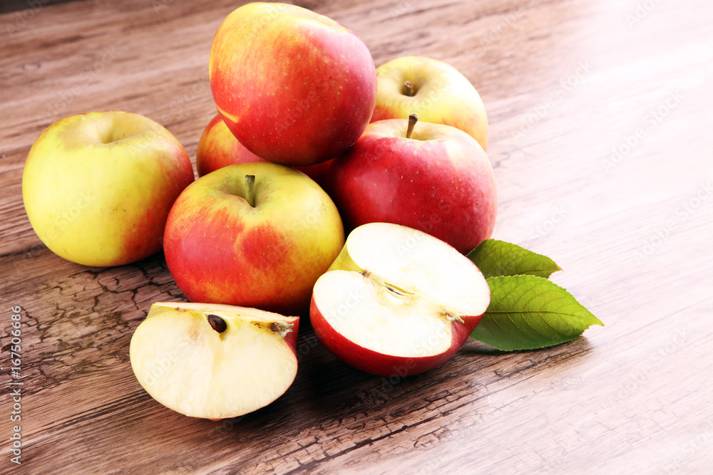 Ripe red apples on wooden background summer concept