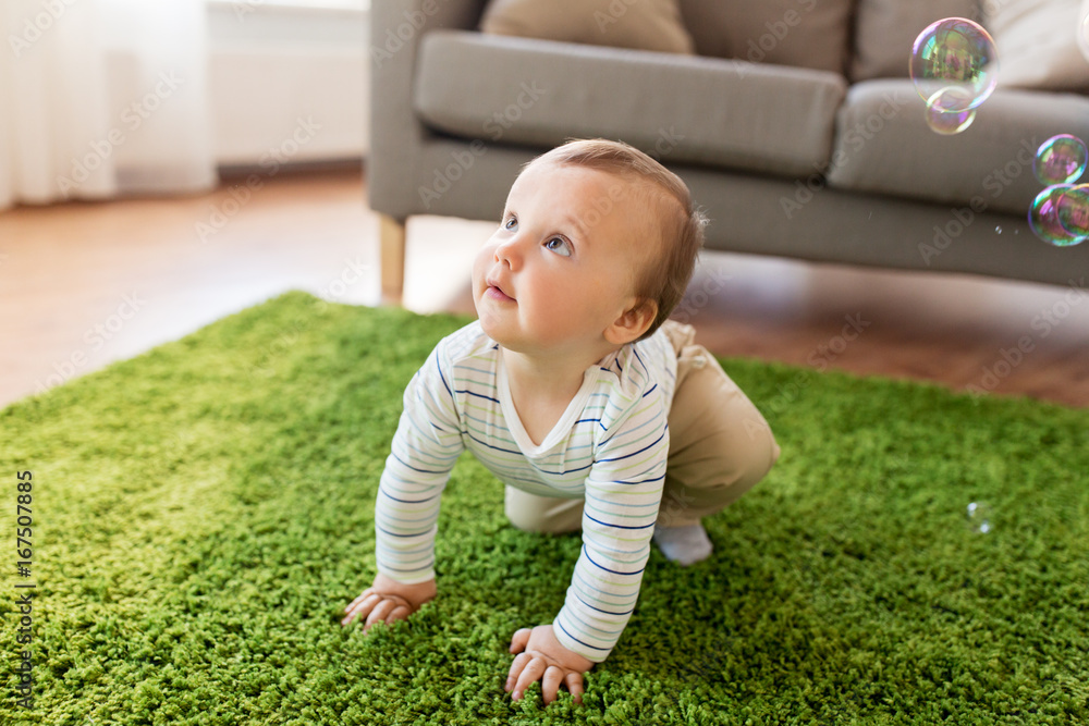baby boy playing with soap bubbles at home baby boy playing with soap bubbles at home