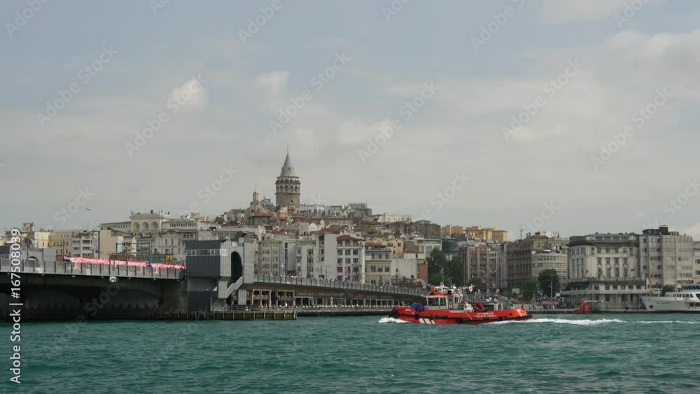 Tug sailing towards the Galata Bridge at the Golden Horn in Istanbul Turkey Tug sailing towards the Galata Bridge at the Golden Horn in Istanbul Turkey