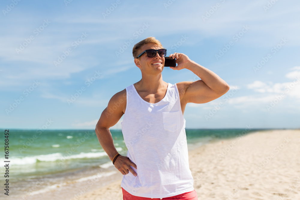 smiling man calling on smartphone on summer beach smiling man calling on smartphone on summer beach