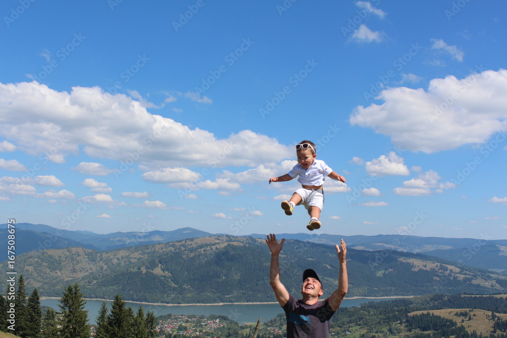 Portrait of cute happy kid small boy in the sky. Child having fun and enjoying sun in the panorama park. concept of flight. Trampolining.