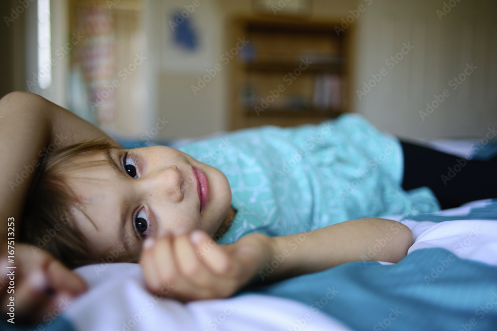 Portrait of confident girl lying on bed Portrait of confident girl lying on bed
