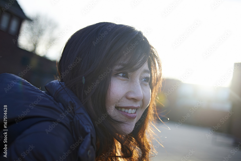 Happy woman looking away on footpath Happy woman looking away on footpath