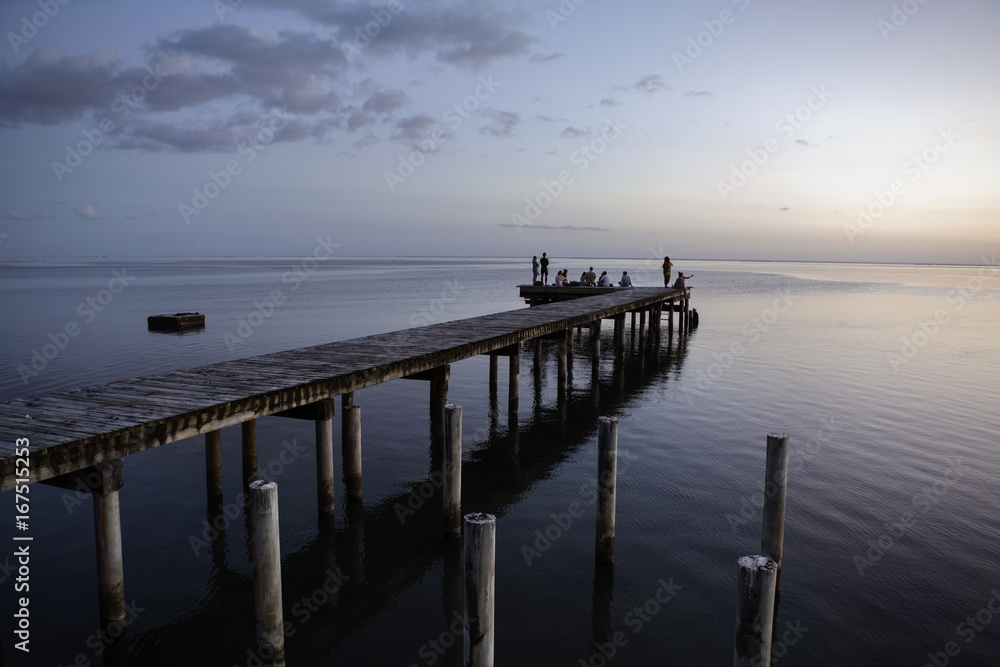 View pier in sea against sky during dusk View pier in sea against sky during dusk