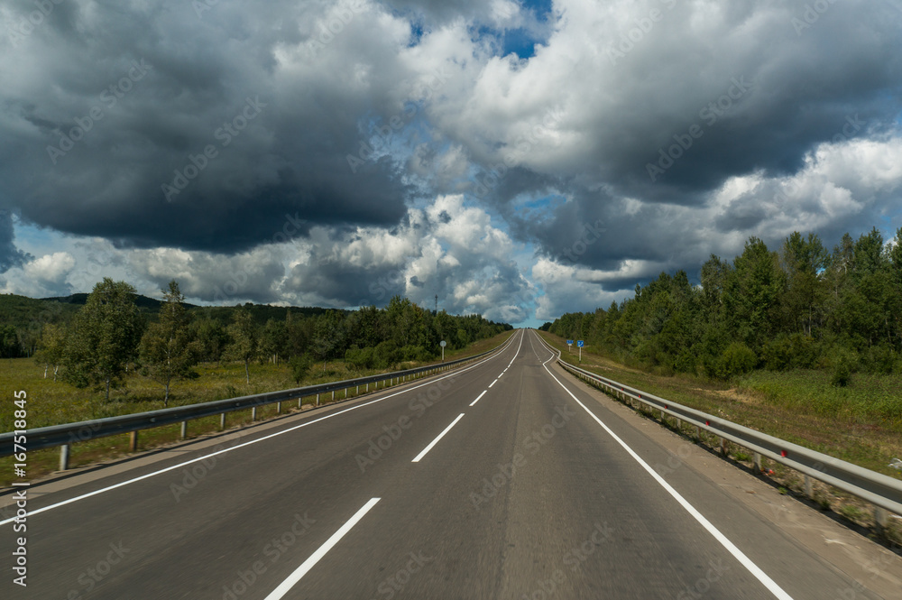 Beautiful sky with grey clouds above the highway in Russia