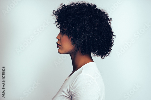 Profile of an attractive African woman against a gray background photo