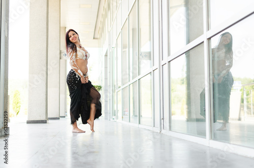 Arab woman dancing in big hallway