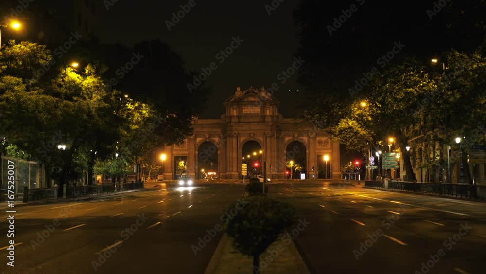 Madrid arch La Puerta De Alcala. Night. Cars are driving. A beautiful sight in a night city. Locked down real time medium shot Madrid arch La Puerta De Alcala. Night. Cars are driving. A beautiful sight in a night city. Locked down real time medium shot