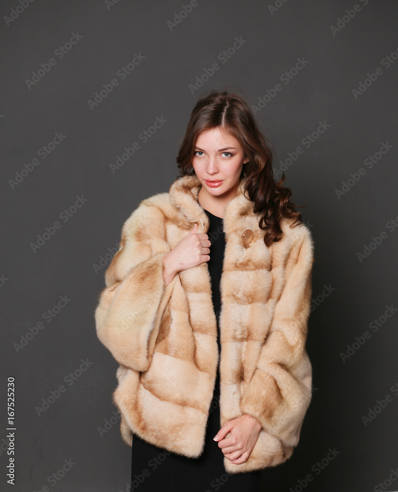 Portrait of a beautiful woman in jacket with fur. Portrait of a beautiful woman in jacket with fur.