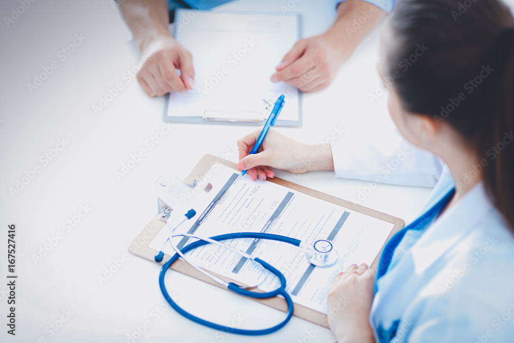 Doctor woman sitting with male patient at the desk
