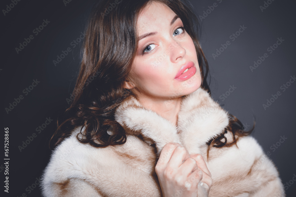 Portrait of a beautiful woman in jacket with fur. Portrait of a beautiful woman in jacket with fur.