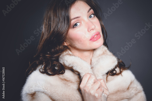Portrait of a beautiful woman in jacket with fur.