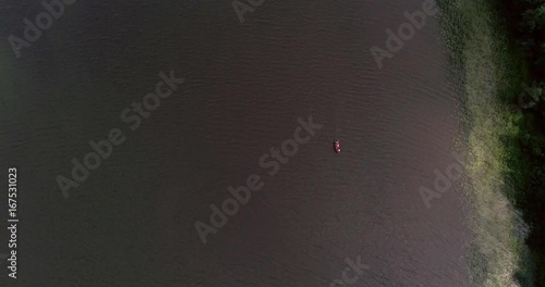 Fisherman on rowboat, Cinema 4k aerial tilt view of fishing men driving on lohjanjarvi lake ,revealing the bridge to lohjansaari island, on a sunny day, in Lohja, Uusimaa, Finland photo