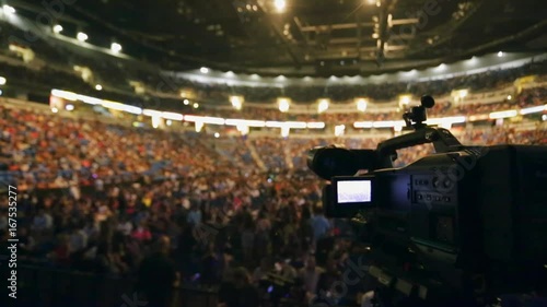 Shot of Video Camera taking video of crowd at packed venue before show starts