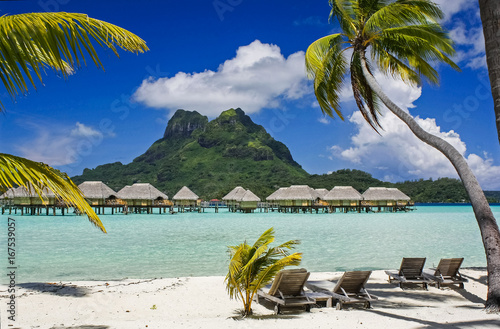 Bora Bora's Mount Otemanu looking down on above water hotel cabins