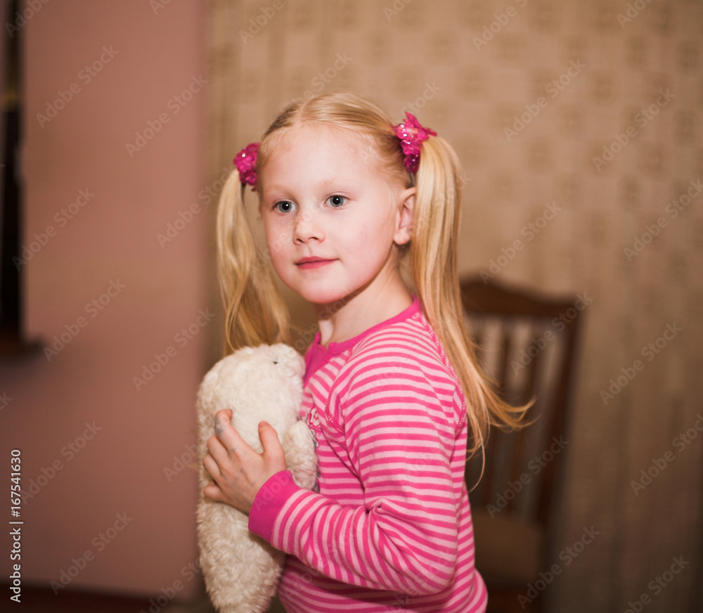 Little blonde girl with a soft toy Little blonde girl with a soft toy