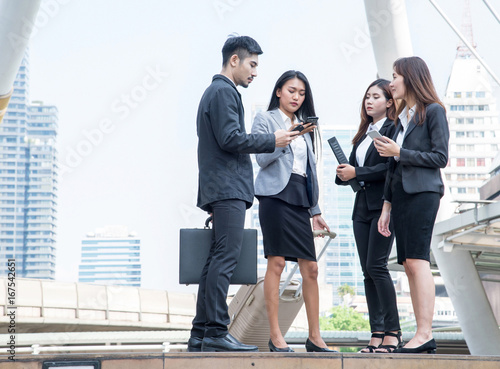 Group of business people talking with mobile phone or tablet, Meeting Communication Discussion Working Concept