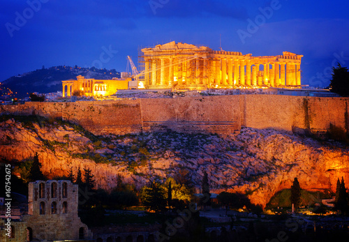 Famous skyline of Athens with Acropolis hill and Pathenon illuminated at night, Athens Greece, retro toned