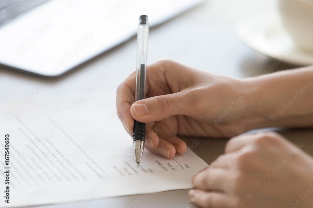 Businesswoman signing document concept, focus on female hand holding pen, putting signature on legal document, giving permission by authorization, subscribing contract, binding agreement, close up Businesswoman signing document concept, focus on female hand holding pen, putting signature on legal document, giving permission by authorization, subscribing contract, binding agreement, close up