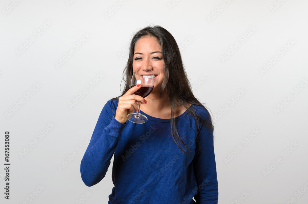 Happy young woman enjoying a glass of wine Happy young woman enjoying a glass of wine
