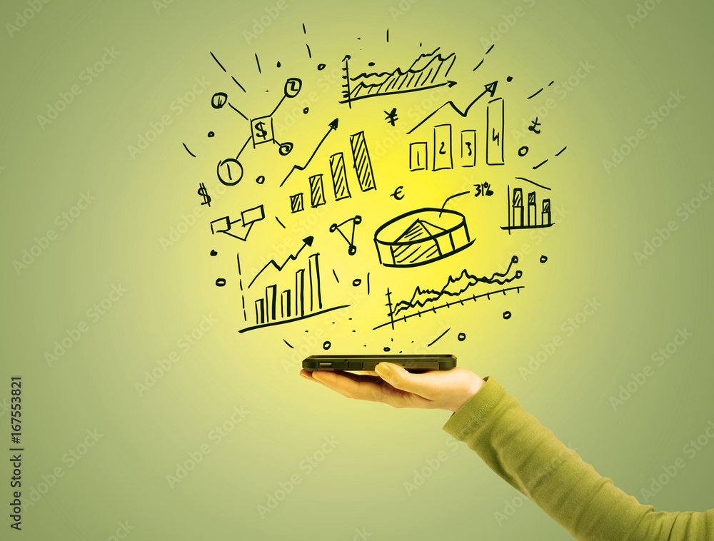 Obraz premium Sales charts on top of mobile phone in hand