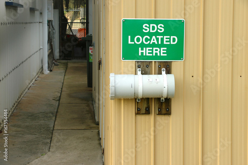 green and white SDS Located Here sign photo