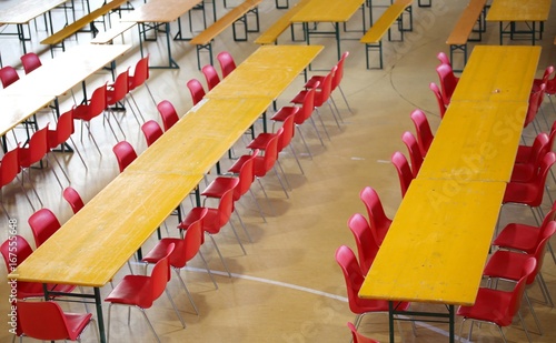 long table with red chairs in a wide classroom
