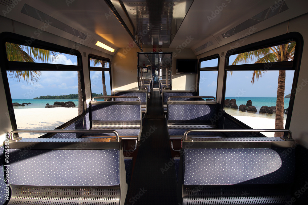 Empty interior of the train for long and short distance in Europe train carriage and tropical blue sea over window. Empty interior of the train for long and short distance in Europe train carriage and tropical blue sea over window.