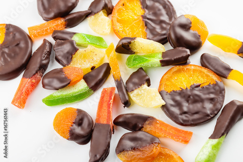 Candied fruit in chocolate on white