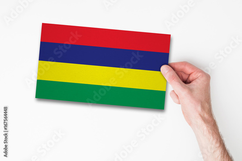 Male hand holding mauritius flag