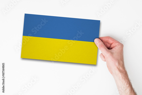 Male hand holding ukraine flag