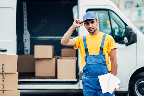 Workman or courier holds carton box in hands