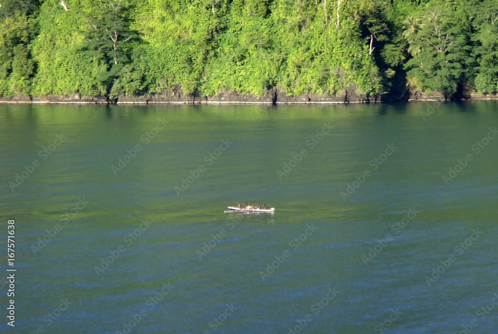 Locals in traditional canoe, Garove Island, Papua New Guinea. Locals in traditional canoe, Garove Island, Papua New Guinea.