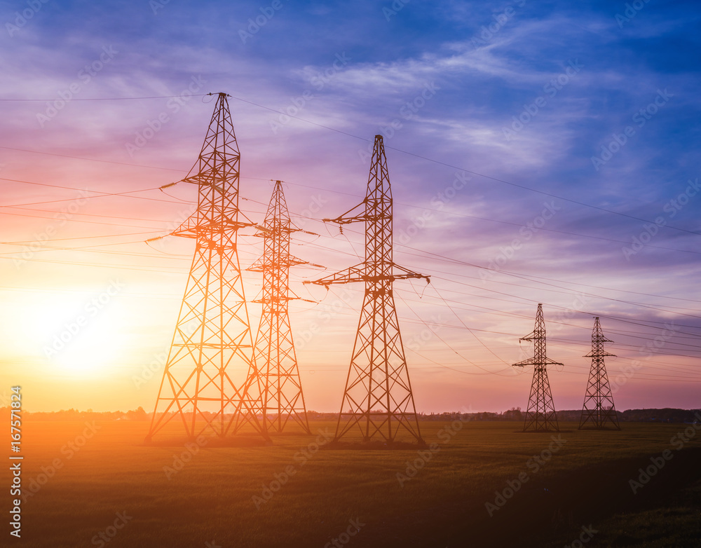 High-voltage power lines at sunset. Electricity distribution station.