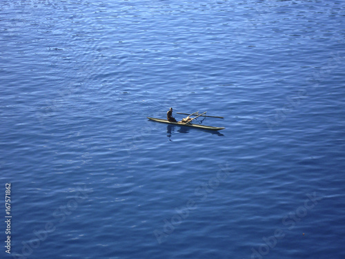 Locals in traditional canoe, Garove Island, Papua New Guinea.
