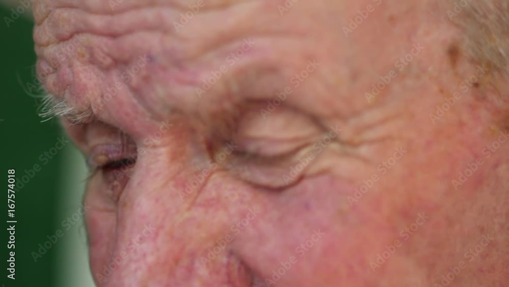 Very old man portrait with emotions. Grandfather sad and depressed. Portrait: aged, elderly, loneliness, senior. Close-up of eyes pensive old man sitting alone outdoors. Slow motion. Very old man portrait with emotions. Grandfather sad and depressed. Portrait: aged, elderly, loneliness, senior. Close-up of eyes pensive old man sitting alone outdoors. Slow motion.