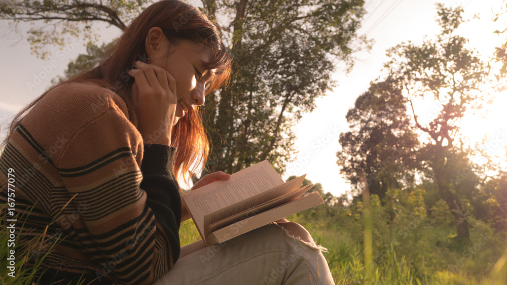 Fototapeta premium the woman reading the book at nature.