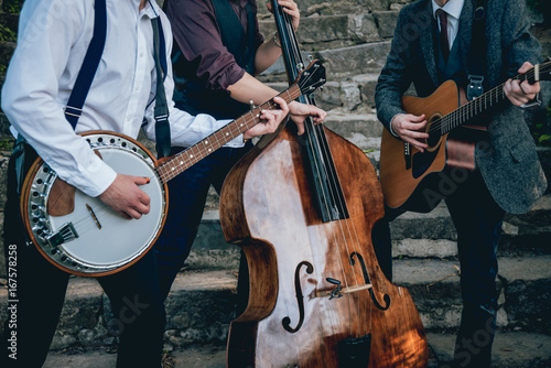 Trio of musicians with a guitar, banjo and contrabass photo