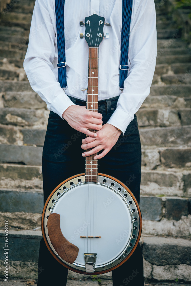 Fototapeta premium View of musician playing banjo at the street
