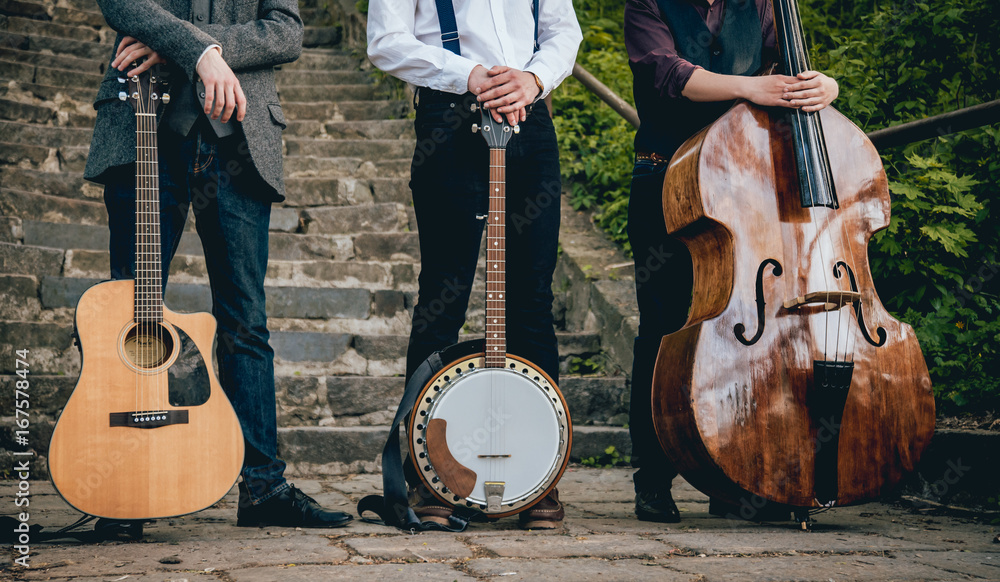 Fototapeta premium Trio of musicians with a guitar, banjo and contrabass