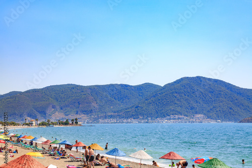 Fototapeta Naklejka Na Ścianę i Meble -  At Calis beach, Fethiye, Turkey- August 1, 2017: People at the Calis beach near center of Fethiye city in Mugla, Turkey