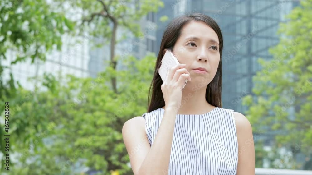 Woman talk to cellphone in Hong Kong city Woman talk to cellphone in Hong Kong city