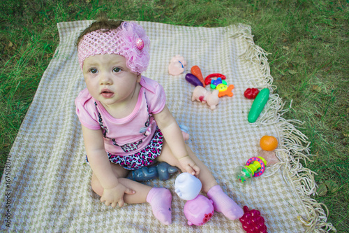 Portrait of a joyful young child outdoors in the park with toys photo