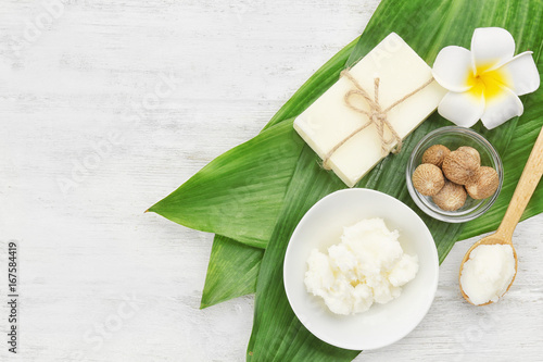 Photography Beautiful composition with shea butter, soap and nuts on wooden table