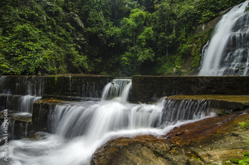 Beautiful in nature landscape  waterfall stream surrounded by green tropical green forest