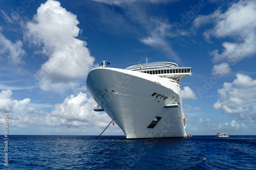 Cruise ship in crystal blue water with blue sky photo