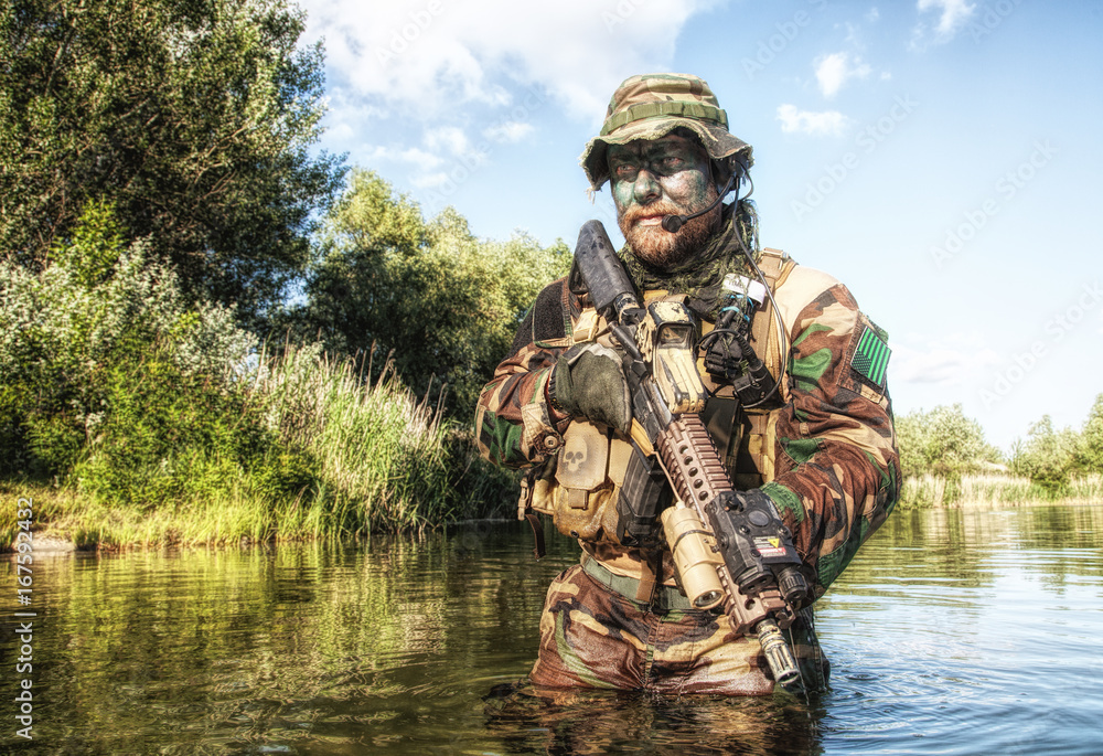 Bearded soldier of special forces in action during river raid in the ...